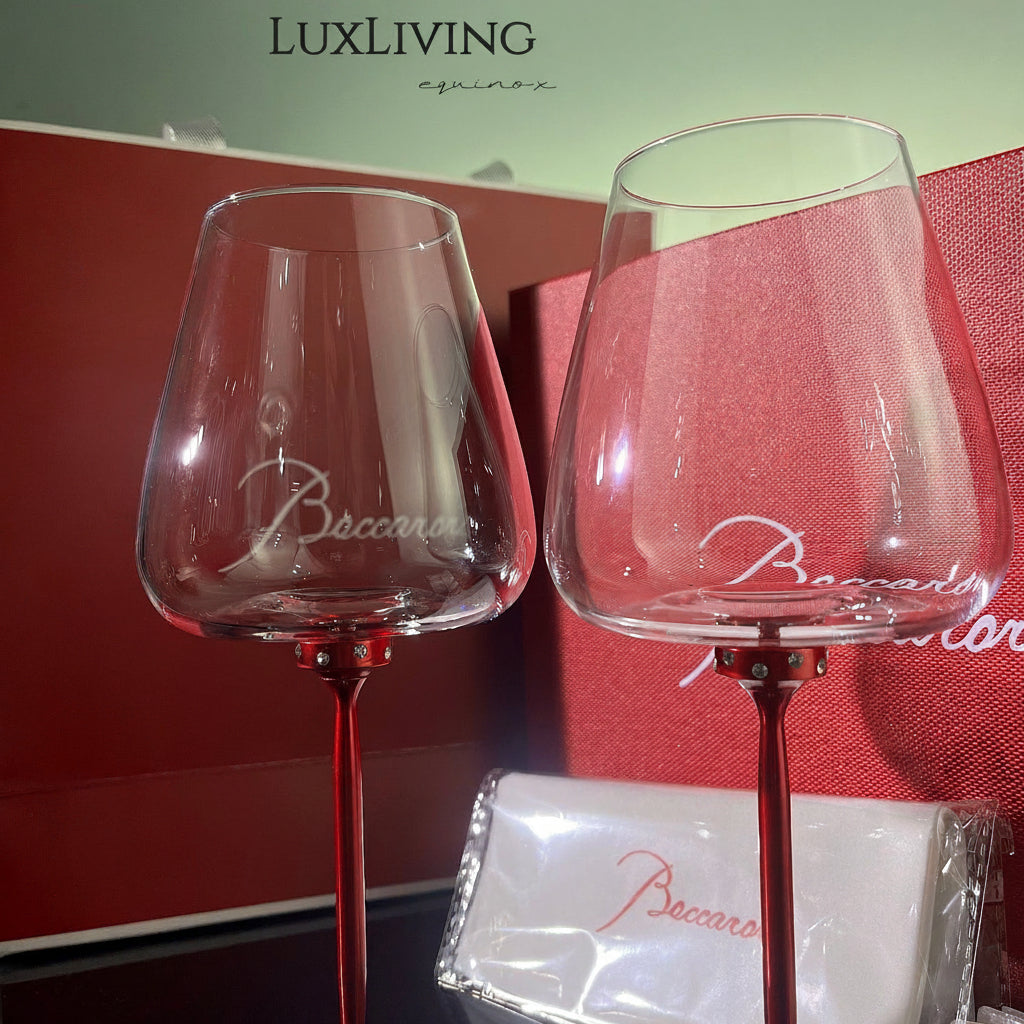 Baccarat crystal glassware gift set features a pair of elegant red-stemmed glasses nestled