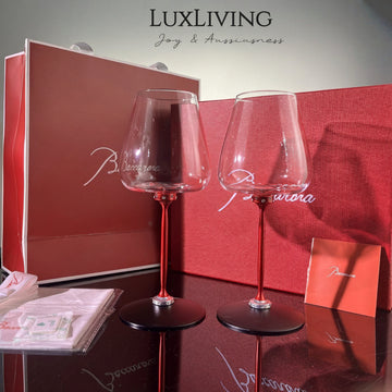 Baccarat crystal glassware gift set features a pair of elegant red-stemmed glasses nestled
