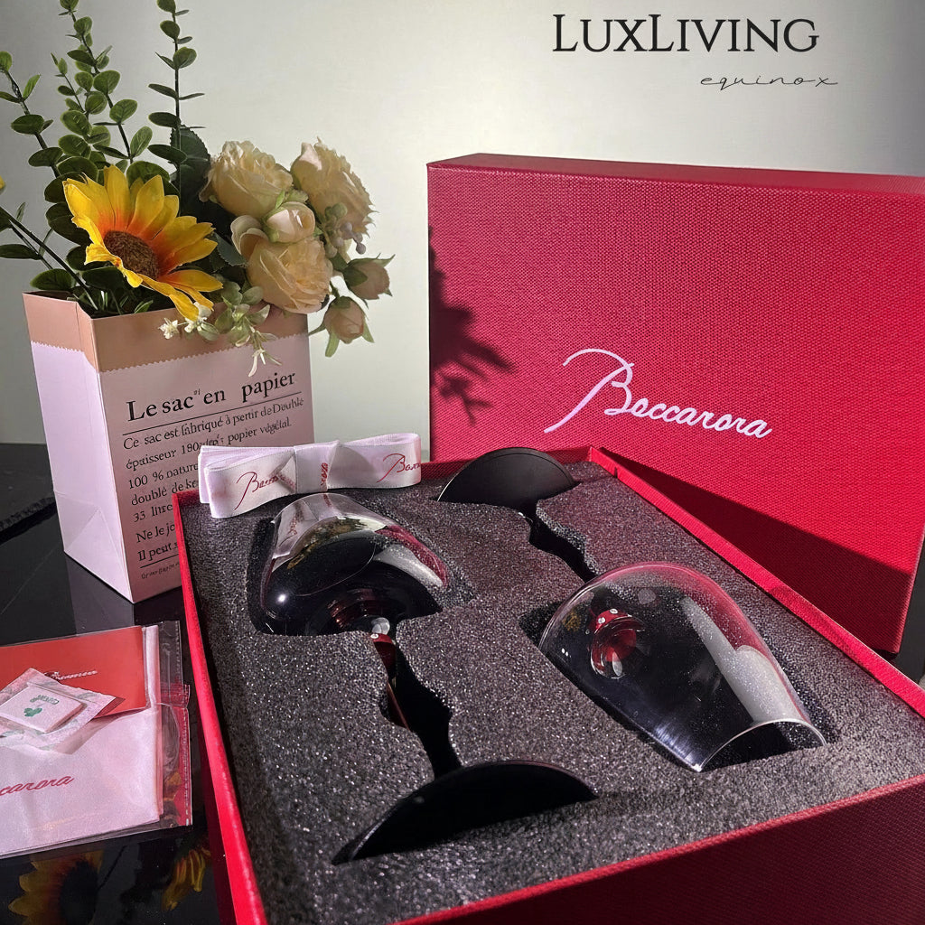 Baccarat crystal glassware gift set features a pair of elegant red-stemmed glasses nestled